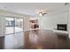 Living room with hardwood floors, fireplace, and access to patio at 1877 Crowley E Cir, Longwood, FL 32779