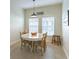 The breakfast nook features a round table with chairs, bright windows, and neutral paint tones at 2048 Gloria Oak Ct, Orlando, FL 32820