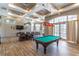 Inviting game room with a pool table, comfortable seating, and stylish lighting fixtures at 2048 Gloria Oak Ct, Orlando, FL 32820