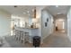 A view of the kitchen island with bar stool seating, stainless steel appliances, and an open floor plan at 2048 Gloria Oak Ct, Orlando, FL 32820