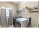 Functional laundry room featuring modern washer, dryer, shelving, and ample storage space at 2048 Gloria Oak Ct, Orlando, FL 32820