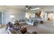 Open living room showcasing a sectional sofa and views of kitchen and hallway at 2048 Gloria Oak Ct, Orlando, FL 32820