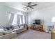 Living room with a sectional sofa and ceiling fan at 2048 Gloria Oak Ct, Orlando, FL 32820