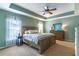 Spacious main bedroom with tray ceiling, large windows, and elegant furniture at 2048 Gloria Oak Ct, Orlando, FL 32820