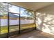 Spacious screened-in porch overlooking the backyard and white privacy fence at 2048 Gloria Oak Ct, Orlando, FL 32820
