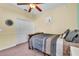 Charming bedroom featuring a double bed, ceiling fan, and built-in closet at 245 Viola Dr, Auburndale, FL 33823