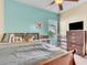 Bright bedroom with a comfortable bed, ceiling fan, and ample storage at 245 Viola Dr, Auburndale, FL 33823