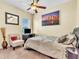 Spacious bedroom with a queen-size bed, city view, and a sitting chair at 245 Viola Dr, Auburndale, FL 33823