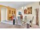 Dining room with glass table and six light beige chairs at 245 Viola Dr, Auburndale, FL 33823