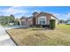 House exterior showcasing a two-car garage and landscaping at 245 Viola Dr, Auburndale, FL 33823
