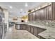 Open concept kitchen with granite counters and stainless steel appliances at 245 Viola Dr, Auburndale, FL 33823