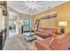 Living room with a brown leather couch and glass coffee table at 245 Viola Dr, Auburndale, FL 33823