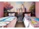 Charming bedroom featuring two twin beds and a fairytale castle mural at 2622 Lodi Cir # 103, Kissimmee, FL 34746
