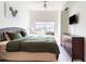 Inviting bedroom features neutral decor, with a large bed, dresser, and window at 2622 Lodi Cir # 103, Kissimmee, FL 34746