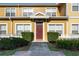 Charming yellow two-story townhome with well-manicured landscaping and inviting front entrance at 2622 Lodi Cir # 103, Kissimmee, FL 34746