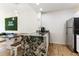 Modern kitchen with a large island and stainless-steel refrigerator at 2622 Lodi Cir # 103, Kissimmee, FL 34746