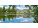 Pond view reflects community homes and lush landscaping for a scenic setting at 2622 Lodi Cir # 103, Kissimmee, FL 34746