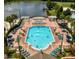 Aerial view of a sparkling pool with a lake in the background at 2622 Lodi Cir # 103, Kissimmee, FL 34746