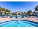 Resort-style pool with comfortable lounge chairs and clubhouse offers a relaxing atmosphere at 2622 Lodi Cir # 103, Kissimmee, FL 34746