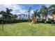 Spacious backyard with playground, volleyball net and lush lawn at 291 Lasso Dr, Kissimmee, FL 34747