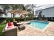 Resort-style backyard with a sparkling pool, spa and patio seating at 291 Lasso Dr, Kissimmee, FL 34747