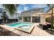 Relaxing pool and spa area with patio furniture and umbrella at 291 Lasso Dr, Kissimmee, FL 34747