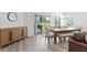 Bright dining area with wooden table, chairs, and large windows at 3220 Sweet Acres Pl, St Cloud, FL 34772