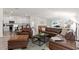 Open concept living room with a sectional sofa, coffee table and kitchen at 3220 Sweet Acres Pl, St Cloud, FL 34772