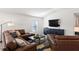 Living room with sectional sofa, large TV, and plenty of natural light at 3220 Sweet Acres Pl, St Cloud, FL 34772
