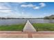 A long wooden dock on the lake stretches into the distance on a clear, sunny day at 349 New Waterford Pl, Longwood, FL 32779
