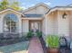 Front entryway with a walkway, landscaping, and a light fixture at 349 New Waterford Pl, Longwood, FL 32779
