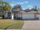 Charming single-story home with a well-manicured lawn and an attached two-car garage at 349 New Waterford Pl, Longwood, FL 32779