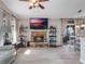 Living room with stone fireplace, built-in shelving and hardwood floors at 349 New Waterford Pl, Longwood, FL 32779