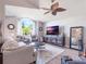 Spacious living room with a large TV, comfortable furniture, and hardwood floors at 349 New Waterford Pl, Longwood, FL 32779