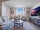 Living room with large window, comfortable seating and hardwood floors at 349 New Waterford Pl, Longwood, FL 32779
