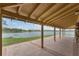 Covered patio area with lake view, supported by tan columns, offering a great gathering spot at 349 New Waterford Pl, Longwood, FL 32779