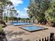 Relaxing community pool and spa surrounded by lounge chairs and landscaped greenery on a sunny day at 349 New Waterford Pl, Longwood, FL 32779