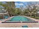A rectangular community pool with a six foot depth has some leaves floating in the water at 349 New Waterford Pl, Longwood, FL 32779
