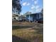 Single-story home with a covered car port, manicured lawn, and mature landscaping at 357 Wade Park Ct, Davenport, FL 33897