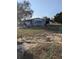 Charming single-story home with light-blue siding, a well-kept lawn, and an attached garage at 357 Wade Park Ct, Davenport, FL 33897