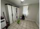 Bedroom with a white wardrobe and tiled floor at 3614 Grice St, Apopka, FL 32703