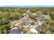 Picturesque aerial view of a residential neighborhood with mature trees and cul-de-sac at 511 Coventry Ct, Mount Dora, FL 32757