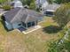 Aerial view of the back exterior featuring a screened in porch and small backyard at 511 Coventry Ct, Mount Dora, FL 32757