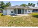View of the back of the house featuring a screened-in porch and compact backyard at 511 Coventry Ct, Mount Dora, FL 32757