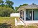 Back of house featuring screened in porch with tile flooring, small yard and privacy fence at 511 Coventry Ct, Mount Dora, FL 32757