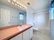 Bathroom with a pink countertop, toilet, and shower-tub combo at 511 Coventry Ct, Mount Dora, FL 32757