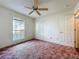 Bedroom featuring ceiling fan, closet and a window at 511 Coventry Ct, Mount Dora, FL 32757