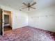 View of a bedroom with a ceiling fan and wall shelving at 511 Coventry Ct, Mount Dora, FL 32757