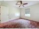 Bedroom featuring ceiling fan and a window overlooking the property at 511 Coventry Ct, Mount Dora, FL 32757