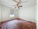 Bedroom with a ceiling fan and a window allowing natural light at 511 Coventry Ct, Mount Dora, FL 32757